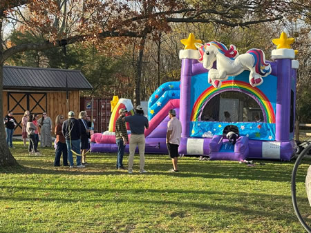 Kids enjoying a colorful bounce house at a baltimore backyard party